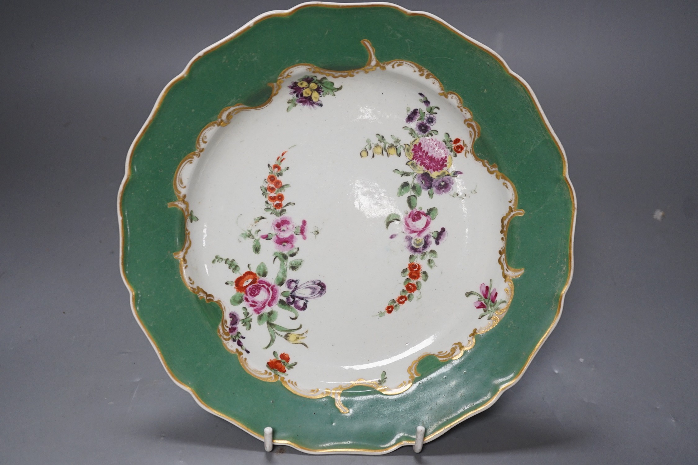 A Worcester plate with apple green border, painted wih two large sprays of flowers and three flower sprigs, known as the Marchioness of Huntly service, see Worcester Porcelain Zorensky, Collection, page 220, plate 252 fo